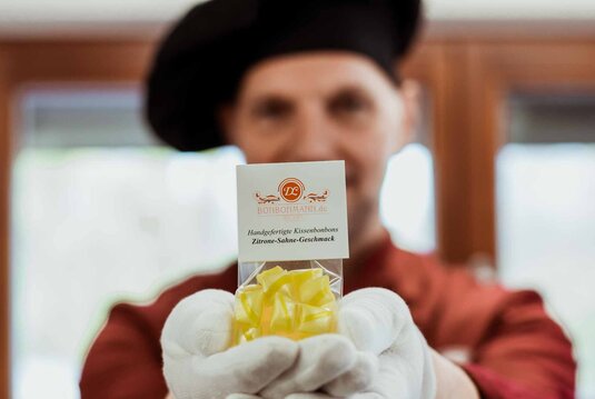 Handmacher Bonbonmann Dirk aus Zeitz mit einer Tüte gelber Bonbons