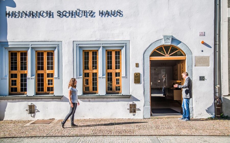 Junge Frau läuft zum Eingang des Heinrich-Schütz-Hauses in Weißenfels