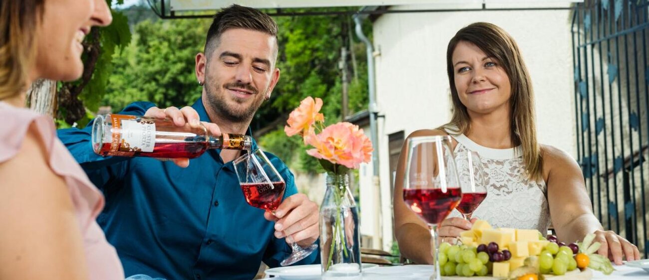 Gäste sitzen auf der Terrasse der Saalhäuser Weinstuben