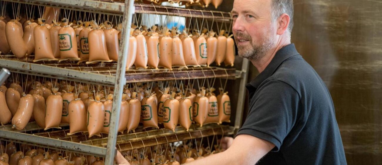 Die Außenansicht und Innenansicht sowie der Chef, Stefan Lüdke, der Filiale der Gönnataler Putenspezialitäten GmbH.